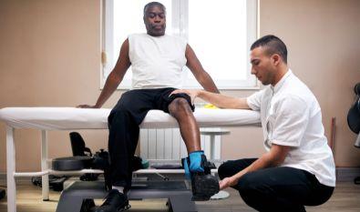 African american man getting physical therapy from a physical therapist