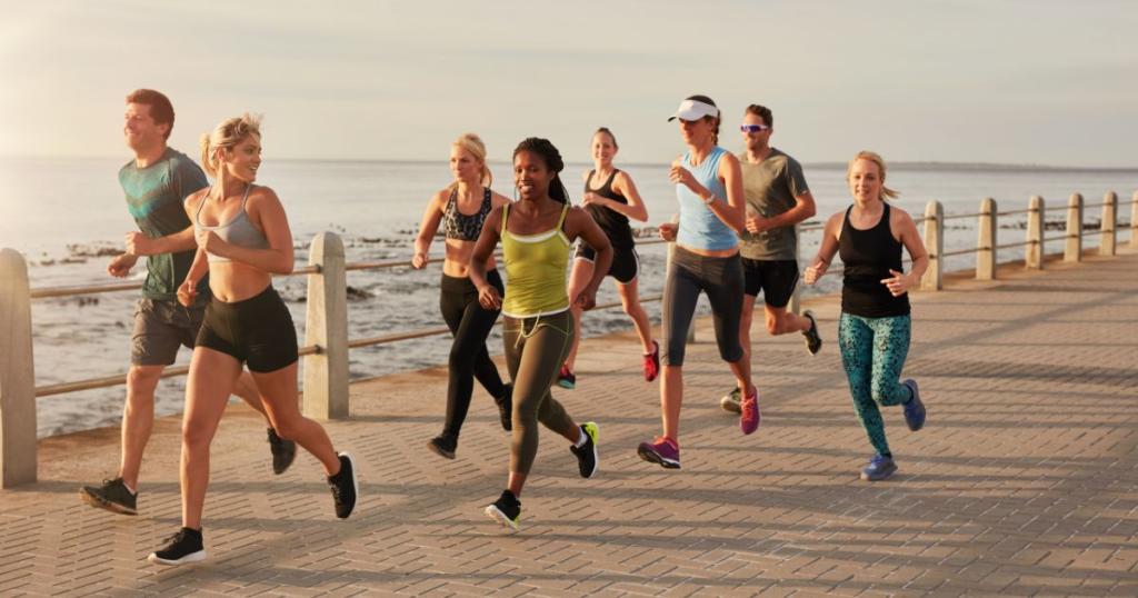 A diverse group of people running on a beach boardwalk