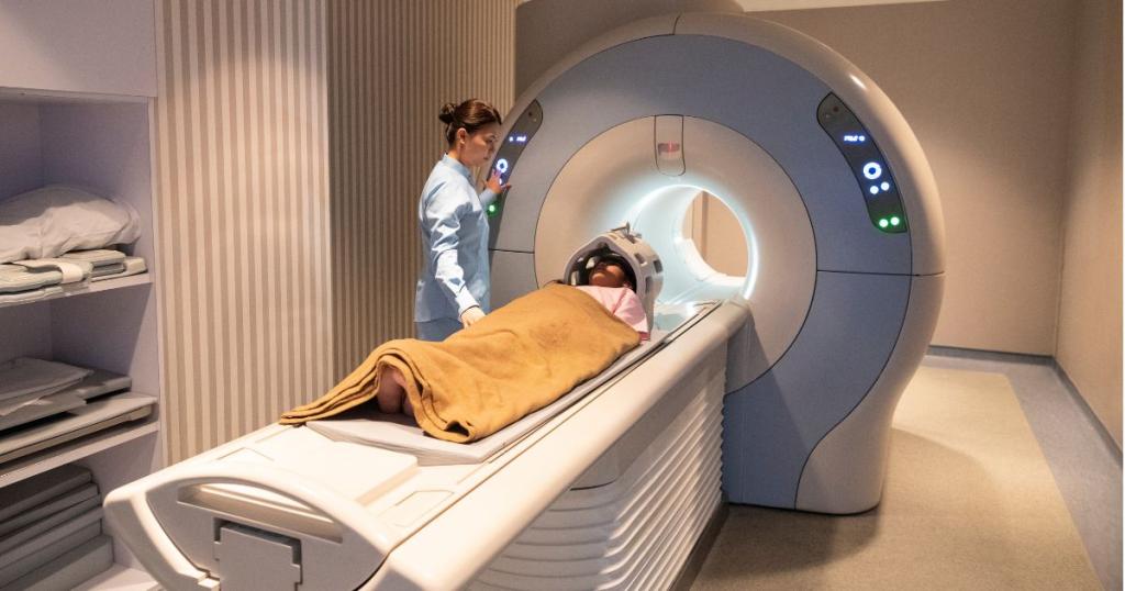 MRI technician assisting a patient in getting an MRI scan using an MRI imaging machine