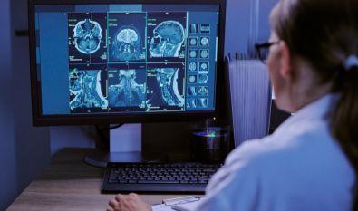 Female orthopedic doctor looking at MRI results on a computer