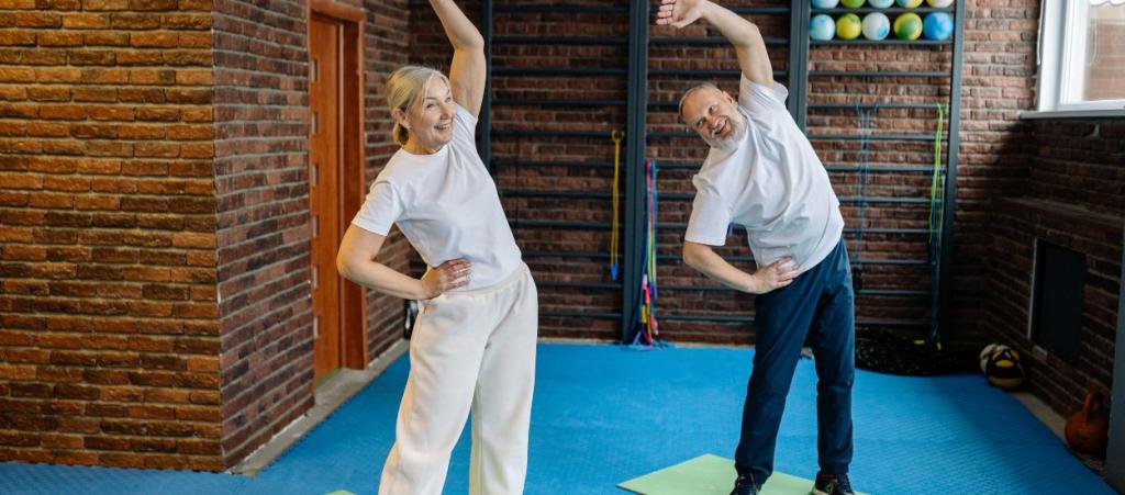 Senior woman and man doing hip flexor stretching at a yoga studio.